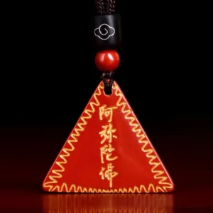 Red cinnabar Amitabha Buddhist pendant necklace with golden engraved characters and wavy gold border on dark background