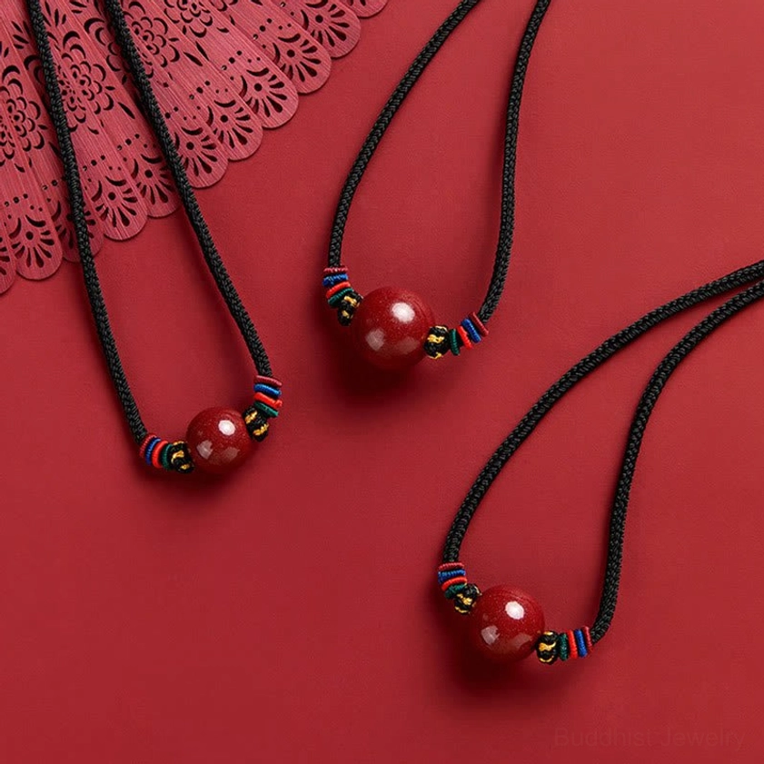 Collection of handmade cinnabar bead necklaces - Buddhist protection pendants with decorative woven knots and braided accents
