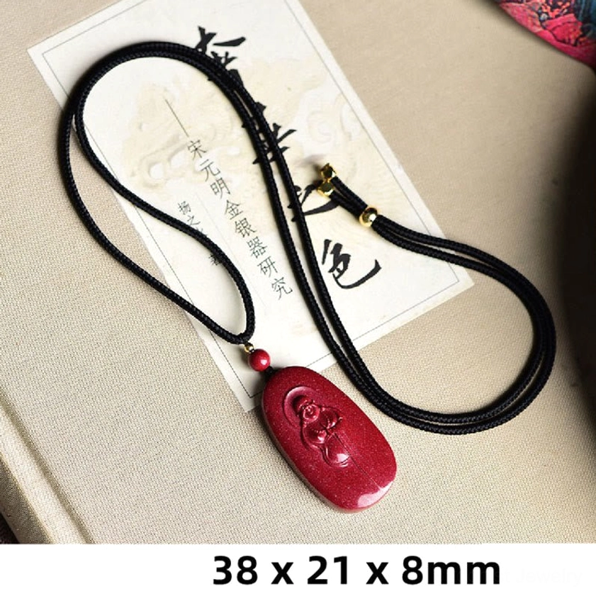 Cinnabar laughing Buddha Buddhist necklace pendant showing size dimensions 38x21x8mm with black hanging cord on antique background
