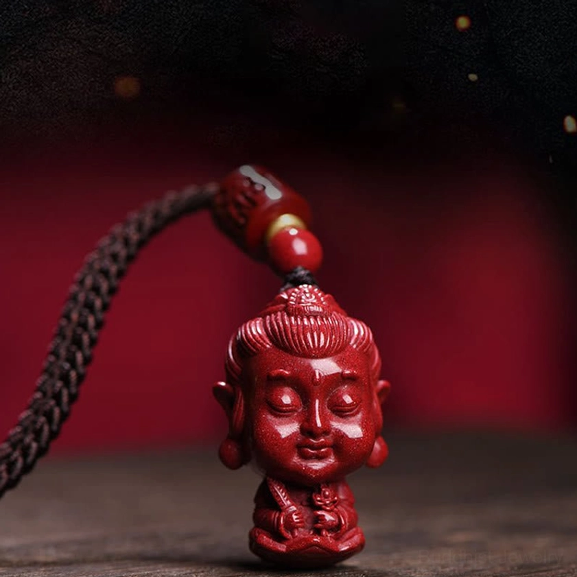 Cinnabar Buddha pendant with prayer bead carving and gold spacer detail