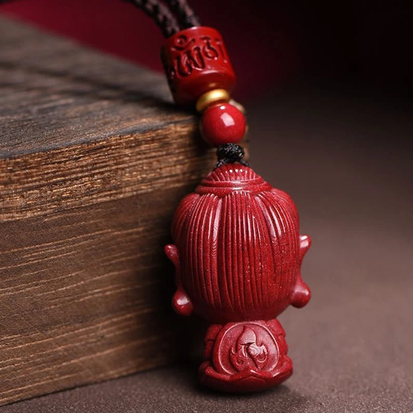 Zodiac natal Buddha cinnabar pendant rear view showing carved details and base