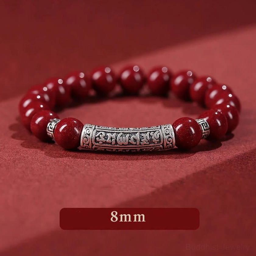 Red cinnabar Buddhist blessing bracelet with silver decorative accents and mantra charm