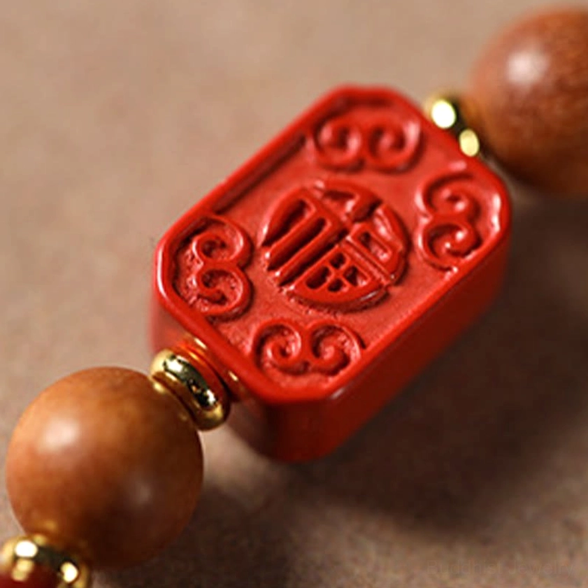 Multiple handmade cinnabar blessing bracelets layered together showing versatility and stacking options