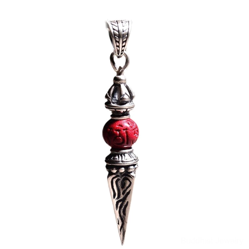 Vintage Cinnabar Dorje Vajra Buddhist pendant with red carved bead hanging shot light background