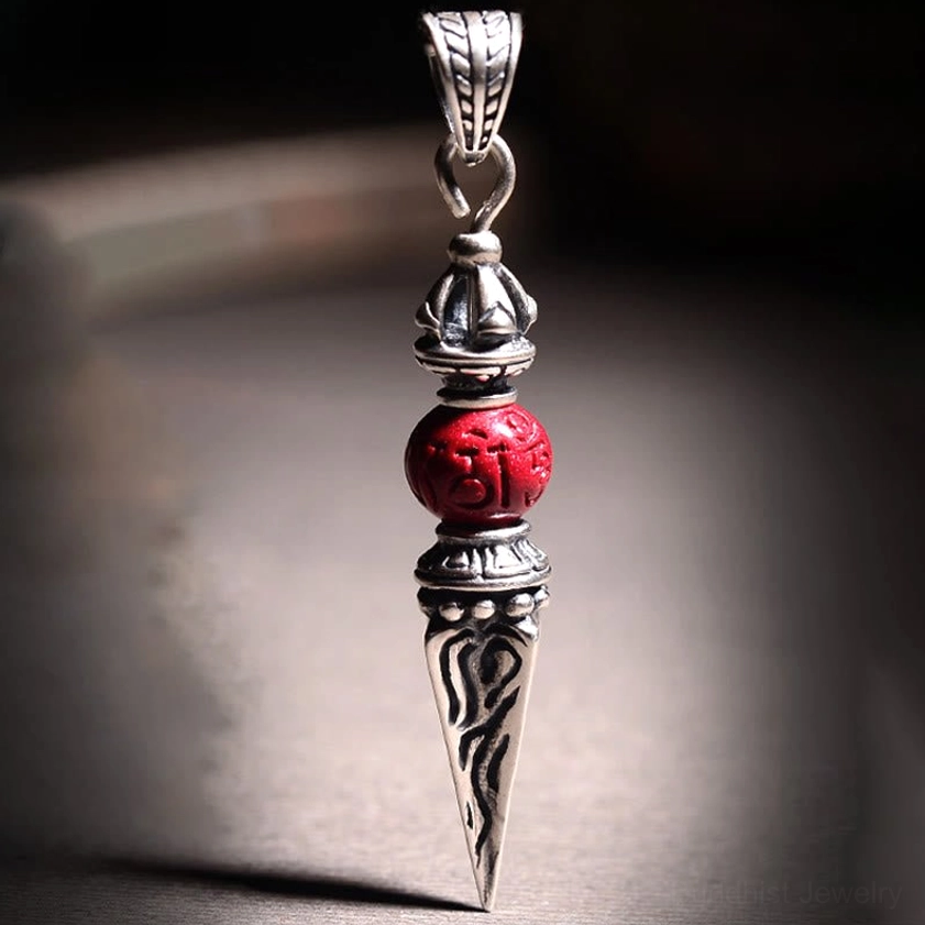 Cinnabar Dorje Vajra pendant close-up front showing carved patterns and ornate silver bail