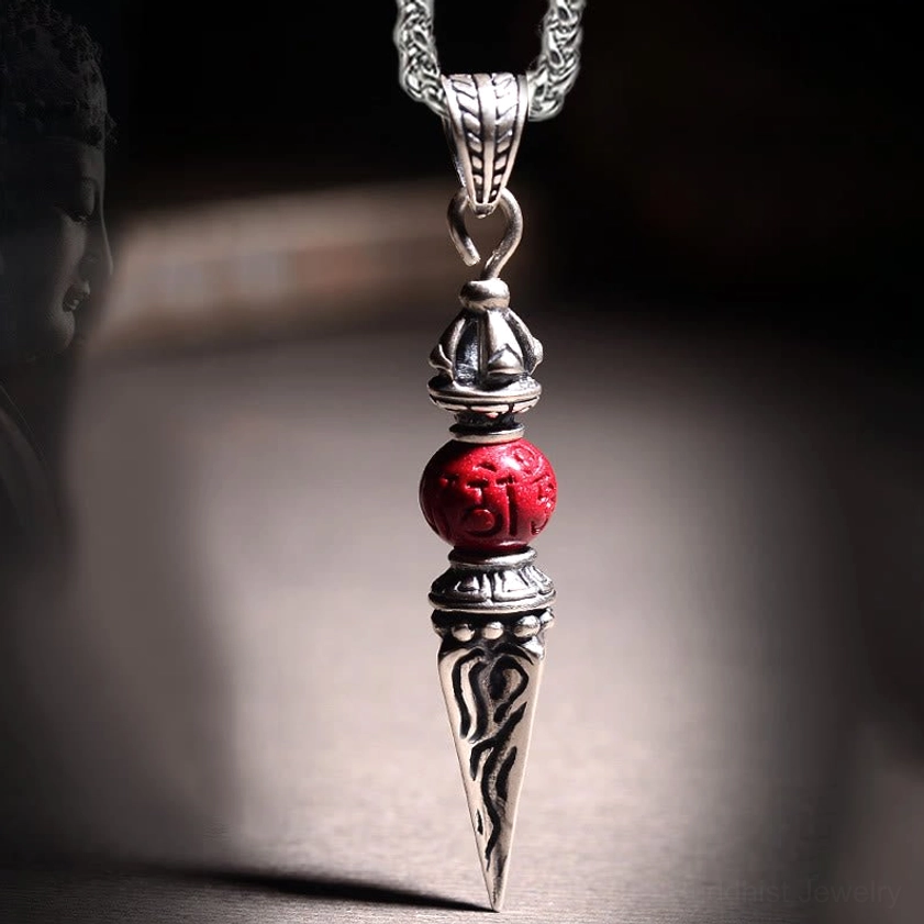 Cinnabar Dorje Vajra Buddhist pendant necklace front close-up showing engraved spike design and red cinnabar bead