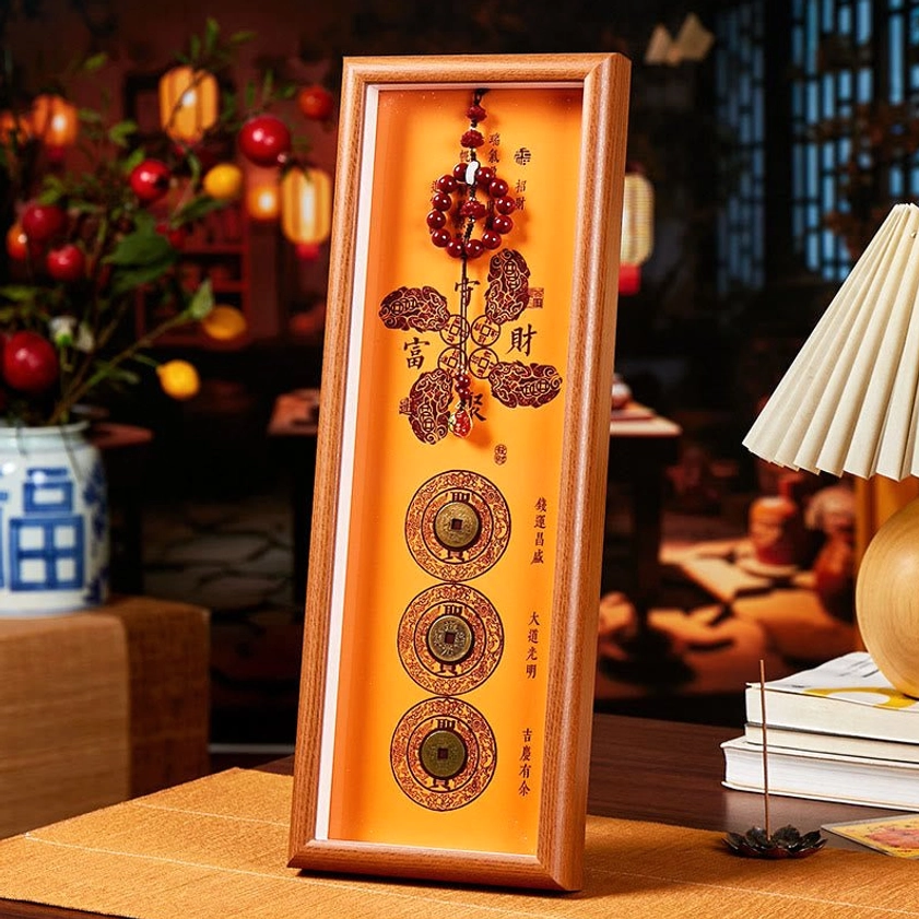Cinnabar copper coin fortune blessing photo frame ornament with red rosary beads and gold patterns on wooden desktop