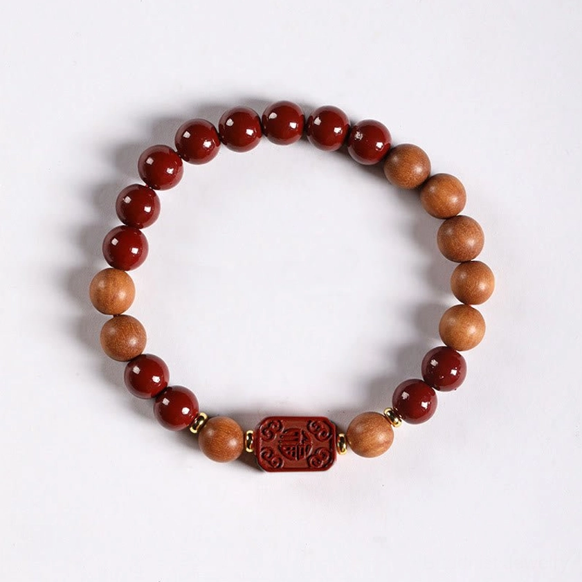 Worn cinnabar fu character blessing bracelet on wrist showing comfortable fit and elastic band design