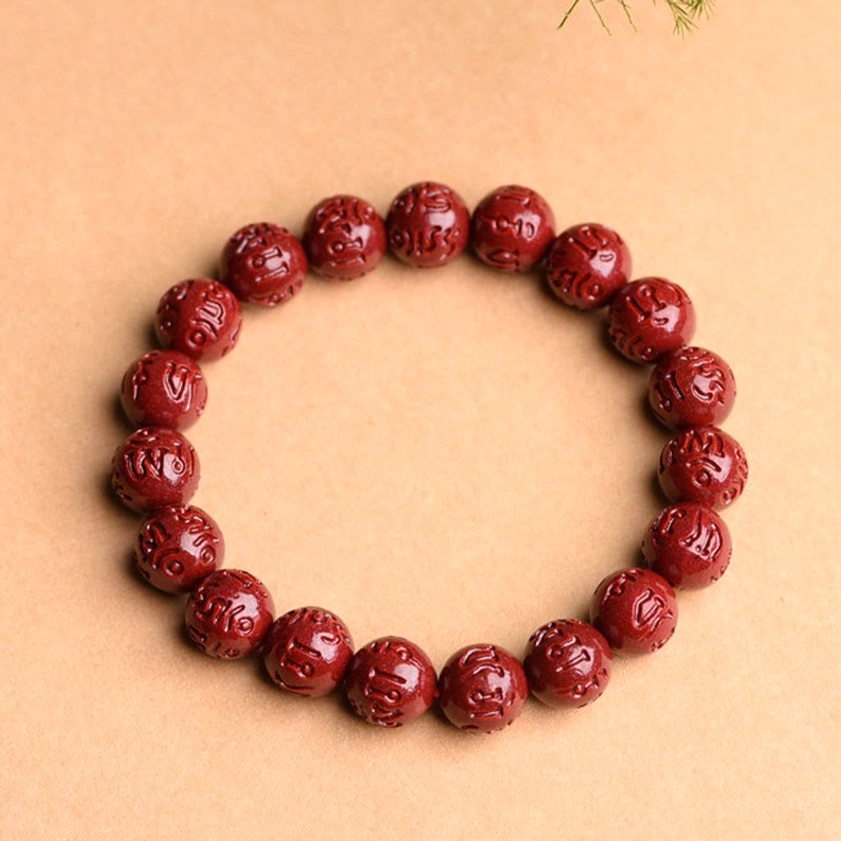 Handmade cinnabar Buddhist bracelet with fret geometric pattern, wine red carved beads with natural stone texture