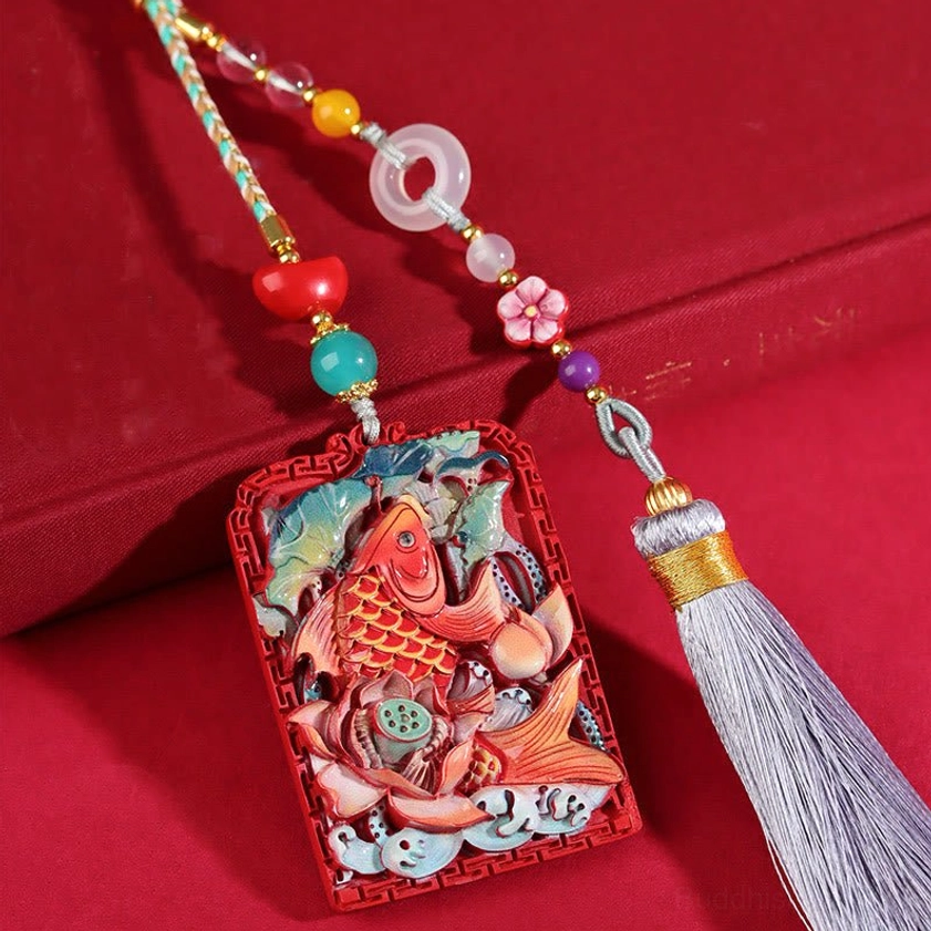 Cinnabar koi lotus car hanging decoration with peace buckle tassel, featuring hand-carved red pendant with colored koi and lotus patterns on red velvet background