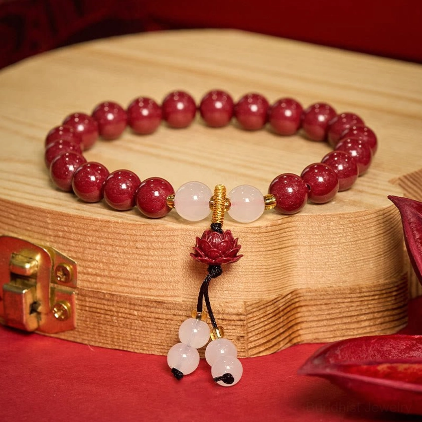 Cinnabar lotus bracelet alternative angle showcase featuring red beads, white jade, and hanging lotus tassel charm for meditation