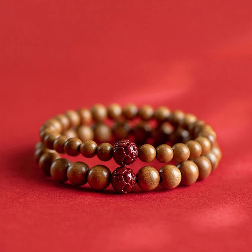 Double-layer Buddhist protection bracelets with multiple cinnabar carved charms and uniform peach wood beads on red background