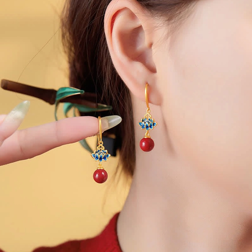 Cinnabar lotus drop earrings detail shot - sterling silver posts blue enamel lotus charms red beads