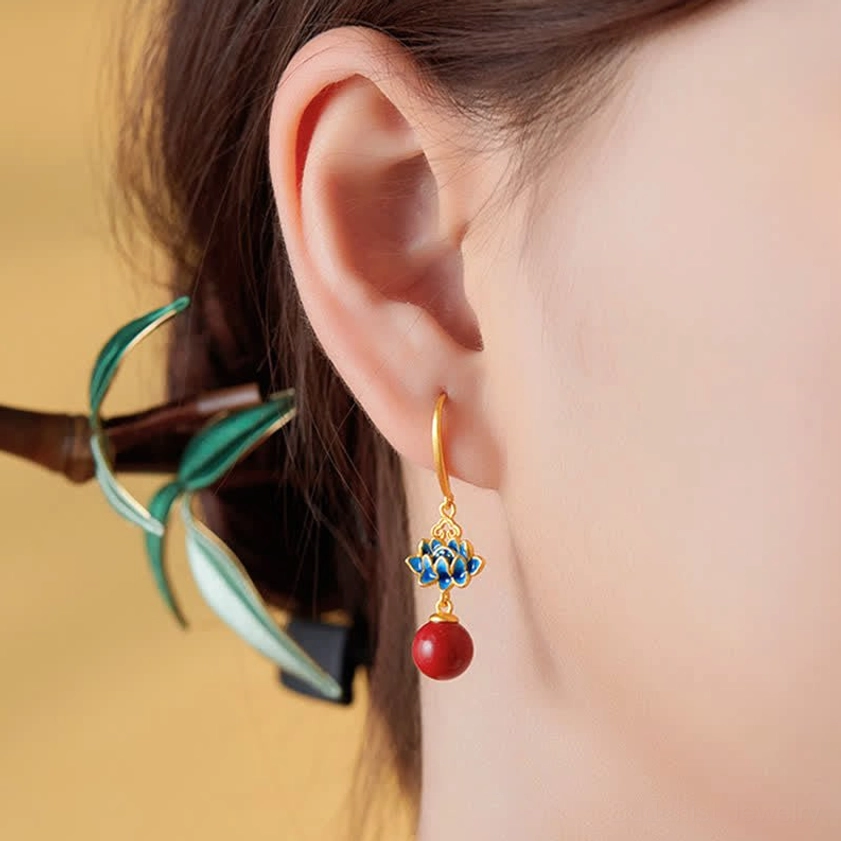 Woman model wearing lotus cinnabar drop earrings with green decorative hairpin - side profile ear close-up
