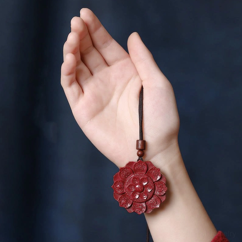 Cinnabar buddhist pendant necklace worn on wrist hand demonstration showing spiritual protection charm