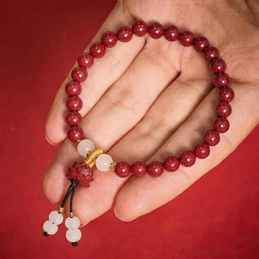 Cinnabar lotus bracelet worn on human hand demonstrating comfortable fit and wearable size for daily meditation and spiritual practice