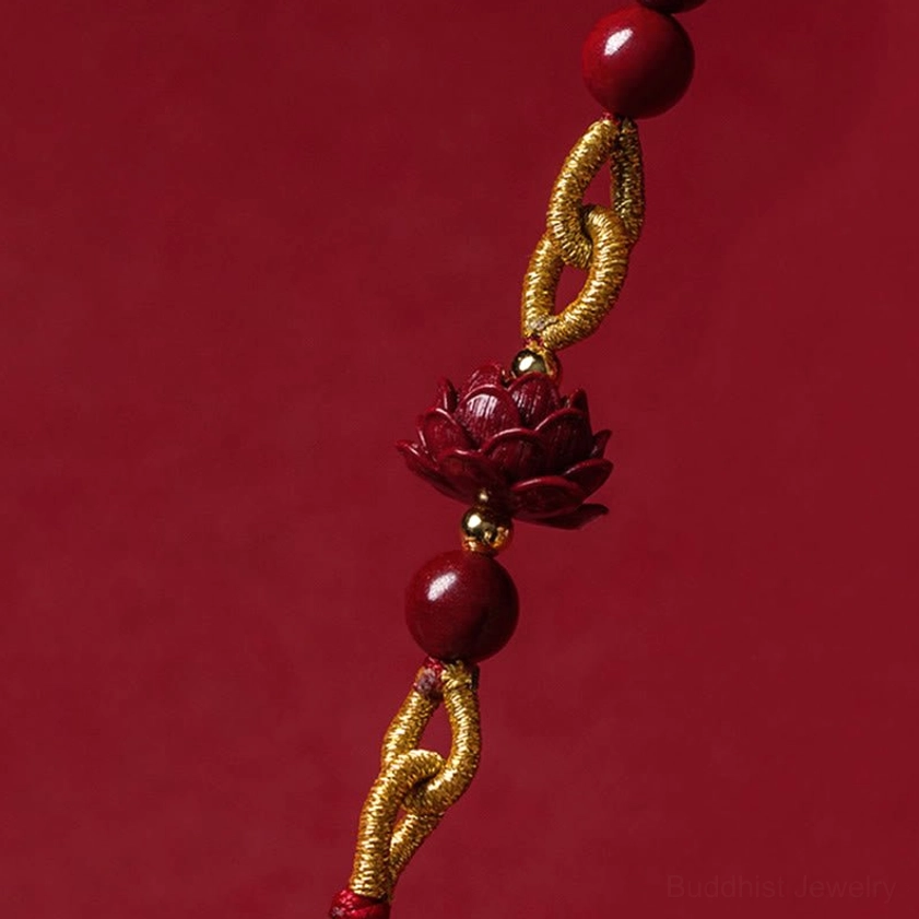 Side view of cinnabar lotus car hanging ornament showing braided golden knots and round beads