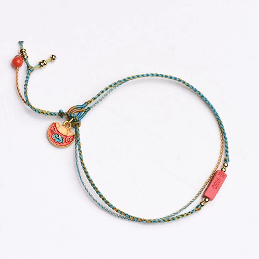 Lucky blue-yellow braided cinnabar bracelet with Ji Xiang auspicious plaque and lock-shaped enamel pendant on book