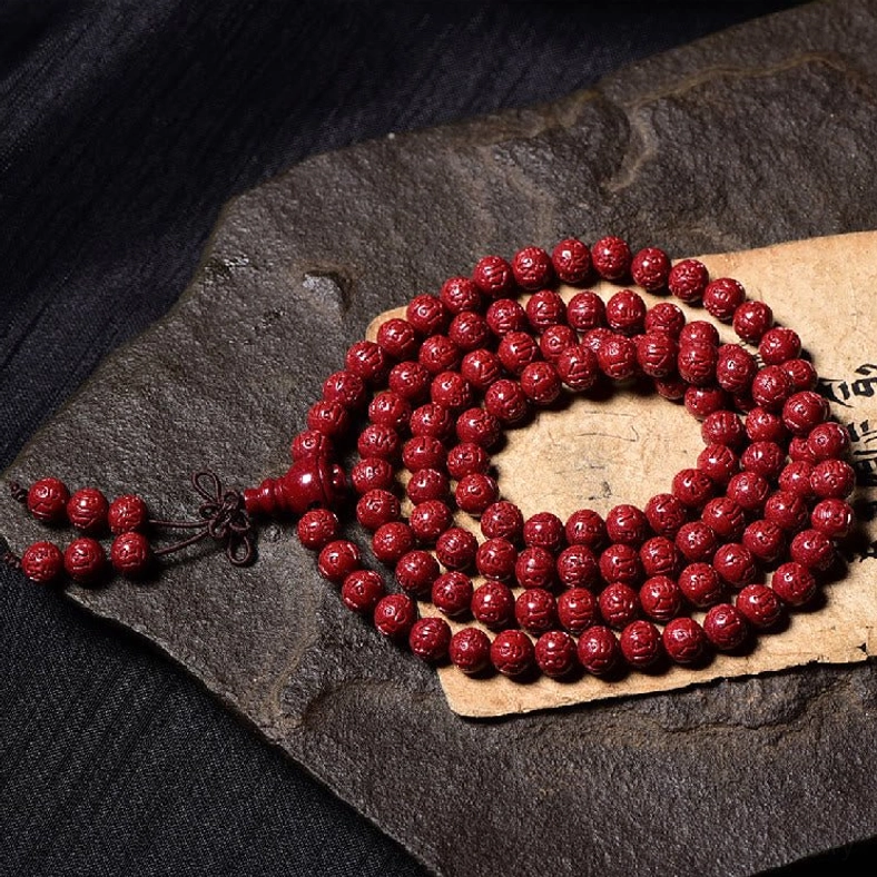 108 cinnabar mala beads prayer bracelet close-up showing bead texture and craftsmanship detail