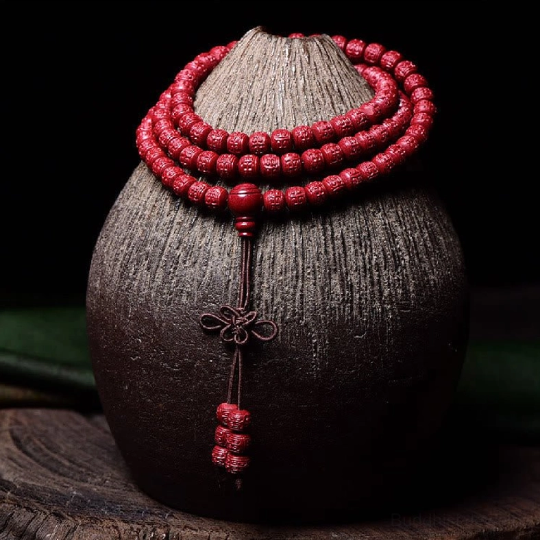 Hand-carved cinnabar 108 mala beads showing intricate pattern and rich red coloration detail