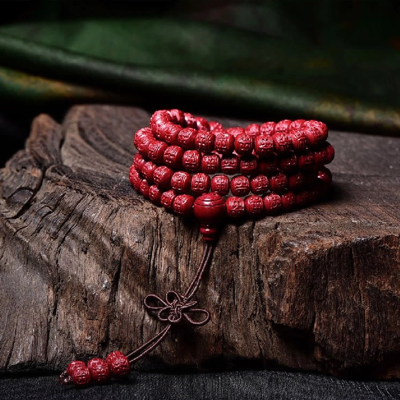 Cinnabar 108-bead mala bracelet with elastic cord and traditional tassel knot styling