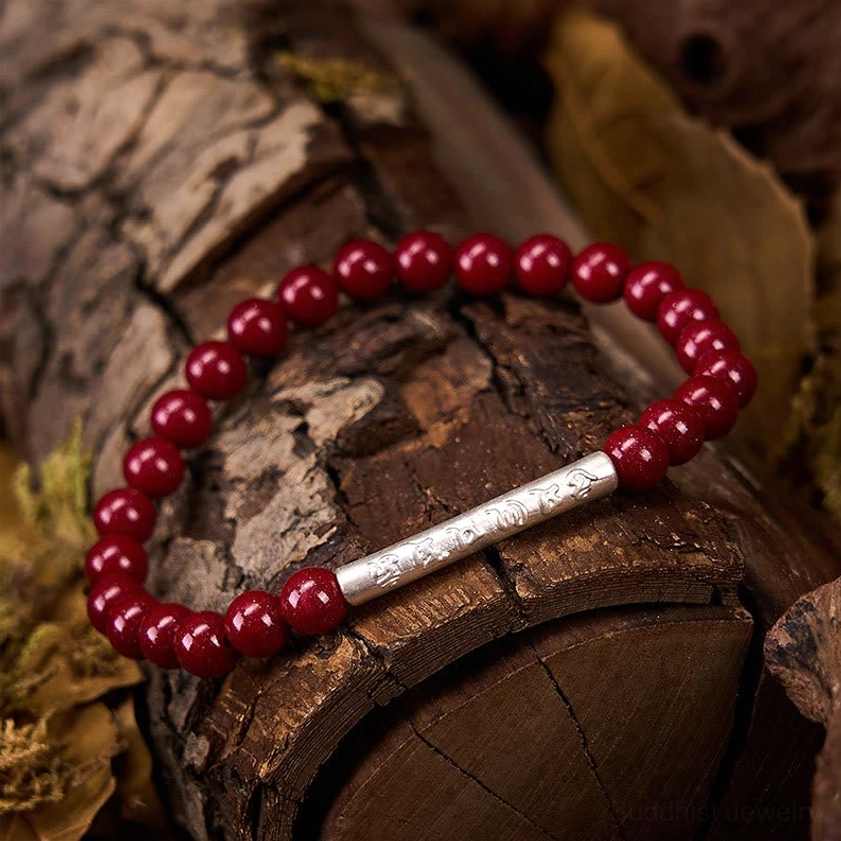Cinnabar beaded Buddhist bracelet with mantra tube, showcasing smooth round beads and premium handcrafted elastic string construction