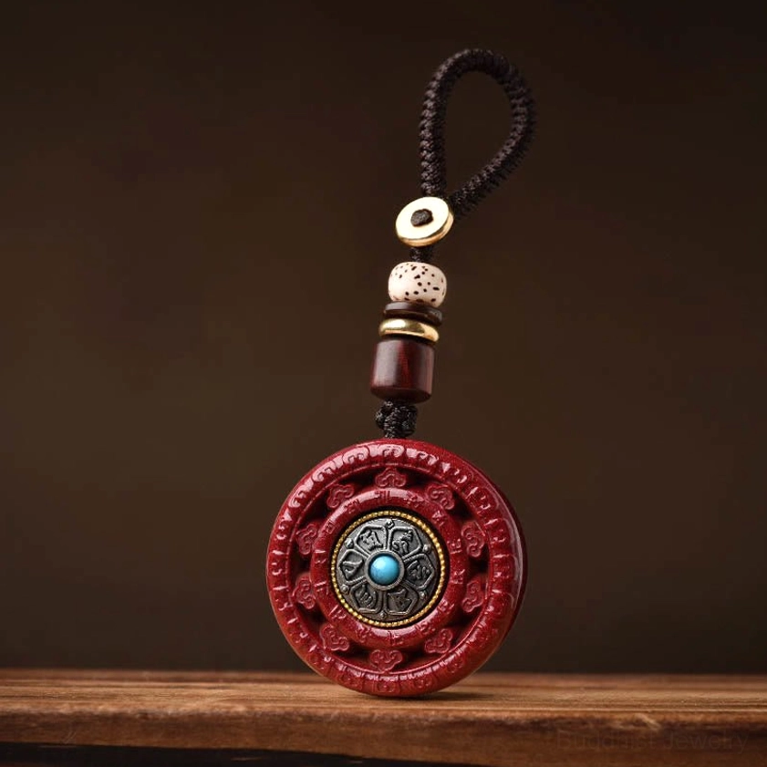 Red cinnabar pendant keychain with silver engraved mantra and natural rope attachment