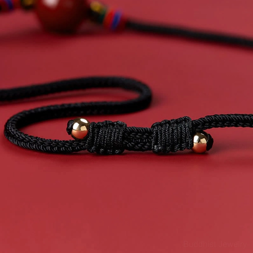 Cinnabar necklace cord with braided black cord and gold spherical end beads - handmade Buddhist accessory detail