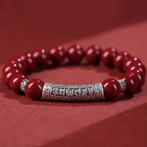 6mm cinnabar and sterling silver Om Mani Padme Hum blessing bracelet flat lay overhead view