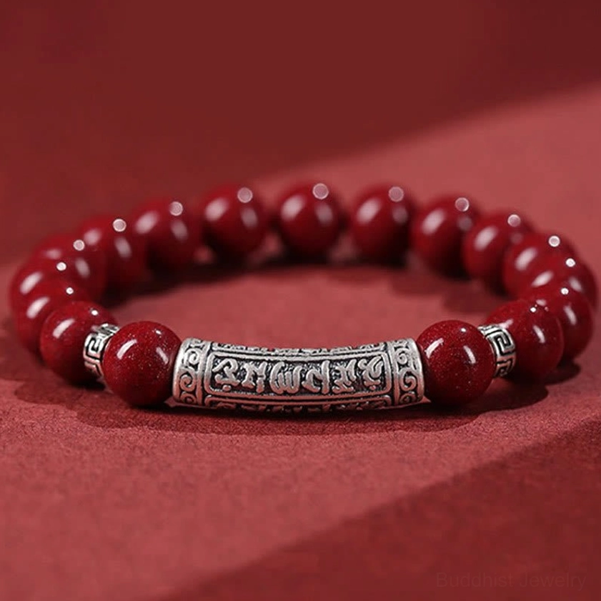 6mm cinnabar and sterling silver Om Mani Padme Hum blessing bracelet flat lay overhead view