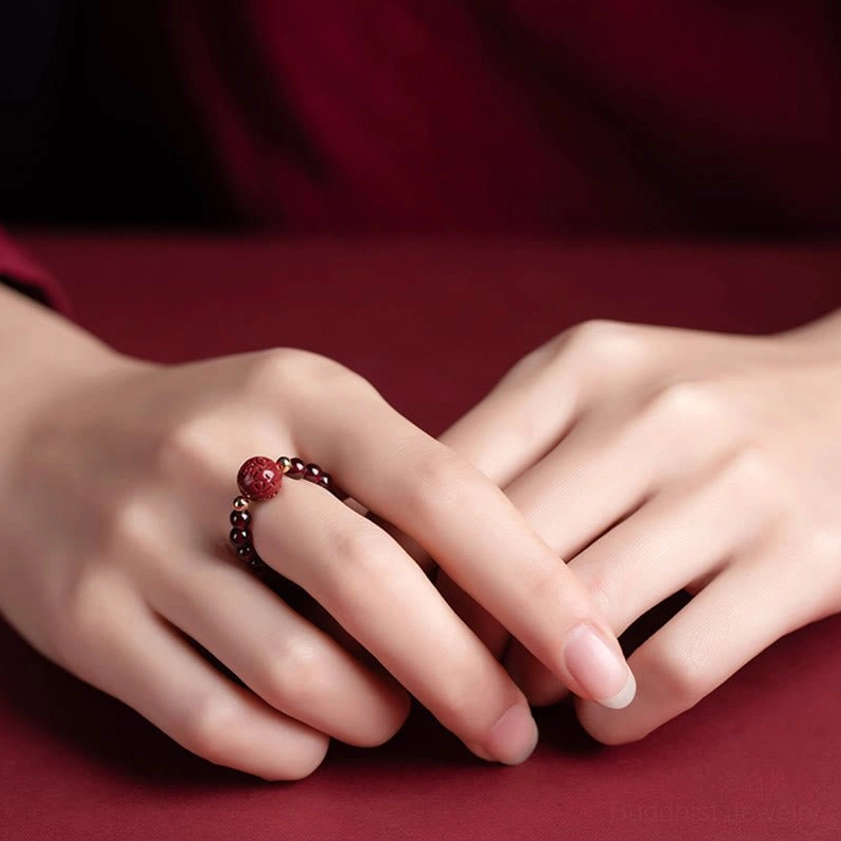 Cinnabar Om Mani Padme Hum Buddhist ring variant featuring sacred mantra engraving, hand-carved beads, and spiritual protection properties on adjustable band