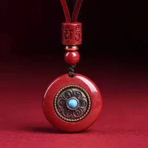 Cinnabar Om Mani Padme Hum pendant necklace with carved six true words mantra and turquoise inlay on red braided cord