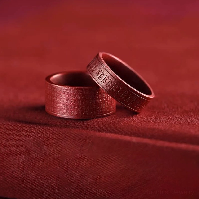 Cinnabar om mani padme hum ring artistic angle view highlighting natural stone texture and engraved sacred text