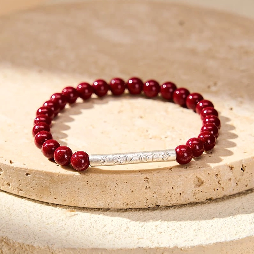 Handmade cinnabar mantra bracelet with premium elastic string, displaying craftsmanship and natural bead variations of authentic Buddhist jewelry