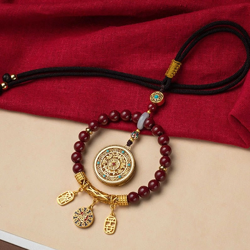 Buddhist cinnabar blessing car ornament with turquoise inlaid gold hardware, protective talisman for safe travels and inner peace