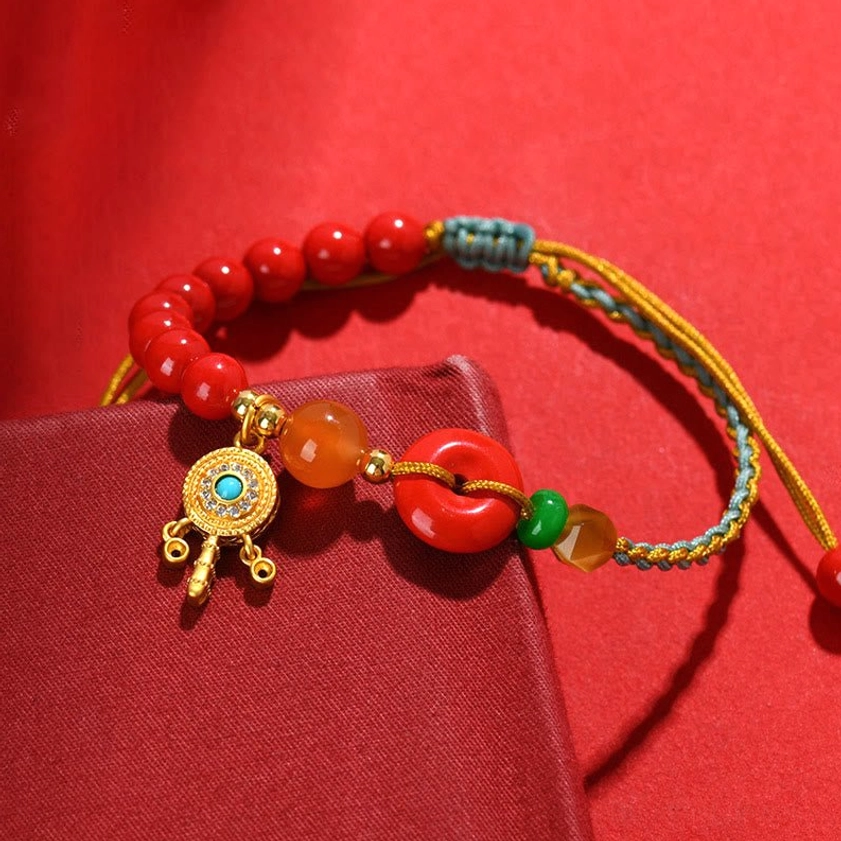 Cinnabar peace buckle Buddhist blessing bracelet lifestyle shot, handmade natural stone and braided cord design