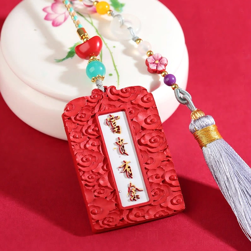 Cinnabar peace buckle car hanging showing Fu Gui You Yu Chinese characters carved on red cinnabar pendant with grey tassel