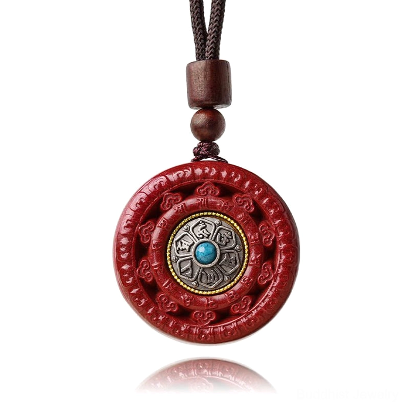 Cinnabar Buddhist pendant with turquoise inlay displayed on dark wooden background