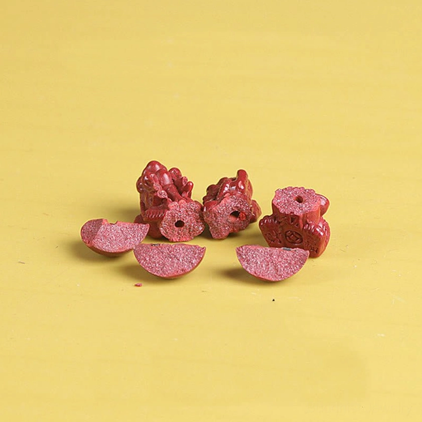 Disassembled cinnabar bracelet components showing individual beads and Pixiu charms
