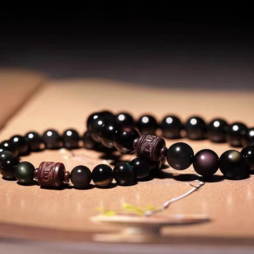 Cinnabar red accent beads on obsidian bracelet adding vitality and grounding energy