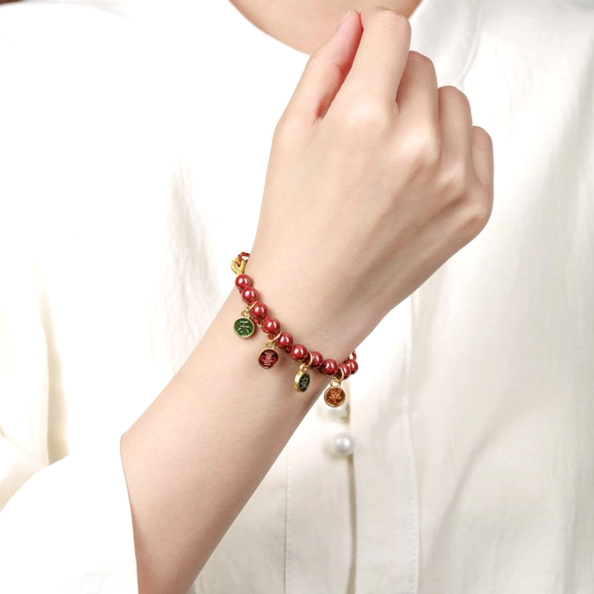 Woman wearing cinnabar blessing bracelet on wrist, lifestyle shot demonstrating comfortable adjustable fit