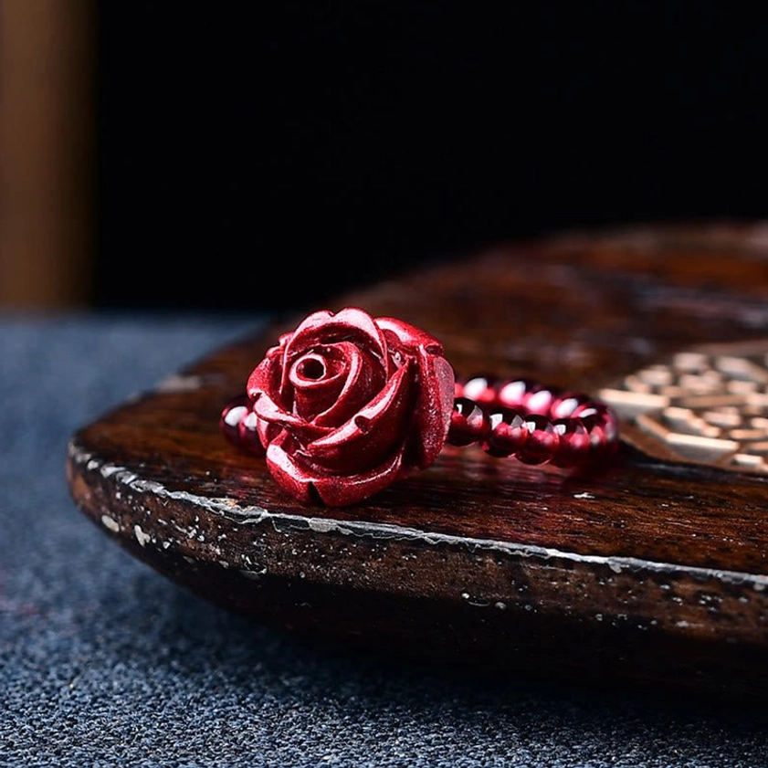Cinnabar rose charm Buddhist ring variant with hand-carved floral design, burgundy beads, and adjustable sizing for spiritual jewelry collection