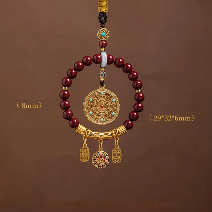 Natural cinnabar blessing ornament detail showing maroon beads, white jade spacer, and gold filigree filigree, authentic Buddhist spiritual piece