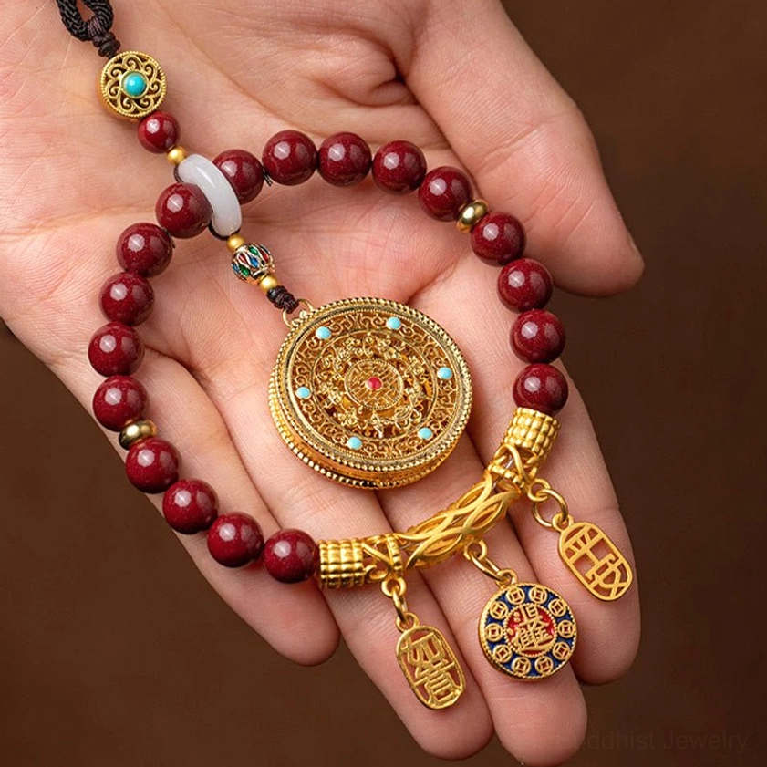 Cinnabar ruyi car hanging charm featuring white jade spacer and turquoise inlaid gold hardware, Buddhist peace and protection talisman