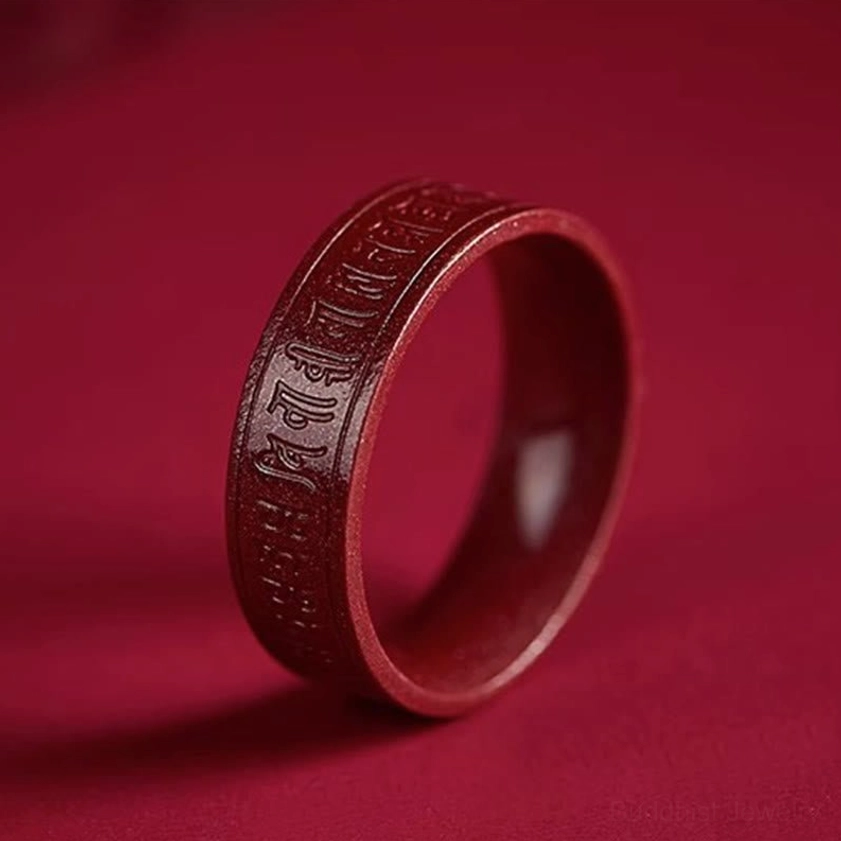 Cinnabar Sanskrit mantra ring full side oblique view deep reddish-brown matte texture with engraved Buddhist script