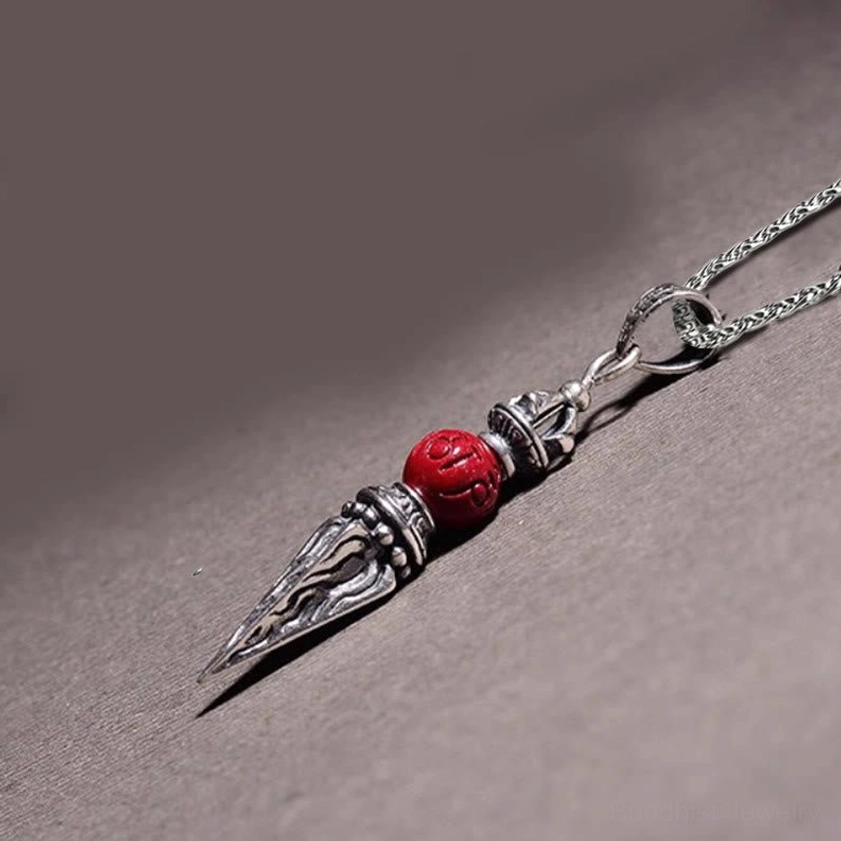 Cinnabar Dorje pendant side profile showing engraved metal spike and attachment loop