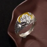 Citrine lotus buddhist ring front view with yellow gemstone and embossed lotus flower carving on vintage copper adjustable band