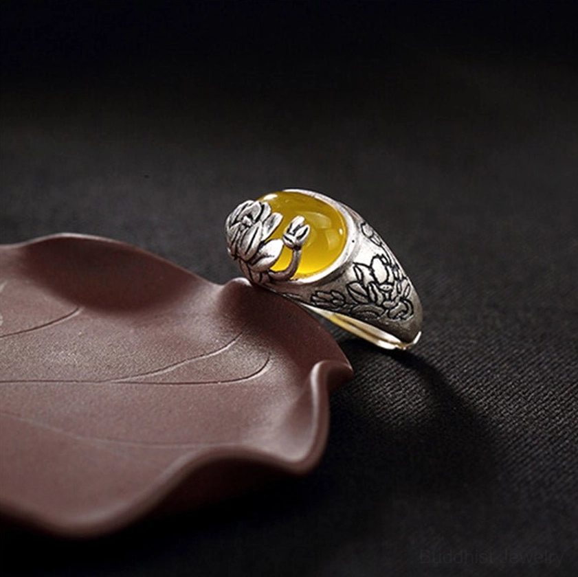 Adjustable citrine lotus ring rear view displaying open copper band design and side profile of yellow gemstone