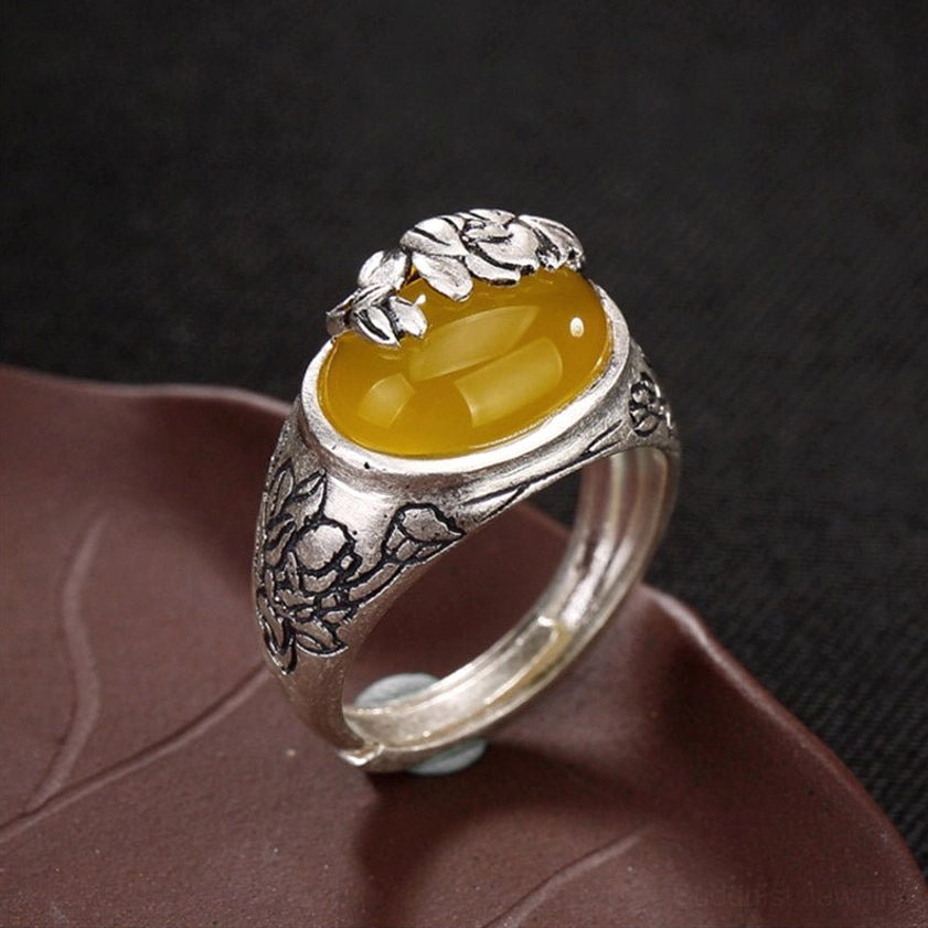 Handmade citrine ring side perspective showing detailed floral silver carving and vintage copper finish with natural patina
