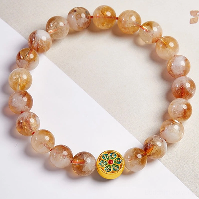 Complete Citrine Om Mani Padme Hum protection bracelet circle with central enamel mantra charm on light tan background
